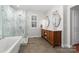 Luxury bathroom featuring a separate shower and tub, double sinks, and modern finishes at 12860 Westmoreland Farm Rd, Davidson, NC 28036