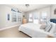 Bright bedroom with a white comforter, ample natural light, and North Carolina Tarheels decor at 12860 Westmoreland Farm Rd, Davidson, NC 28036