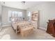 Comfortable bedroom with neutral carpet, a wooden bed frame, and plenty of natural light at 12860 Westmoreland Farm Rd, Davidson, NC 28036