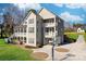 Large gray home with a multi-tiered back porch and outdoor kitchen at 12860 Westmoreland Farm Rd, Davidson, NC 28036