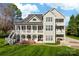 Sprawling gray home with multi-level decks, an outdoor kitchen, and a large yard at 12860 Westmoreland Farm Rd, Davidson, NC 28036
