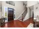 Inviting foyer featuring hardwood floors, staircase, and ample natural light at 12860 Westmoreland Farm Rd, Davidson, NC 28036