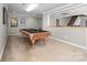 Spacious game room boasts a classic pool table and easy access to the home's second story at 12860 Westmoreland Farm Rd, Davidson, NC 28036