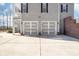 Two-car garage with gray doors and a brick exterior at 12860 Westmoreland Farm Rd, Davidson, NC 28036
