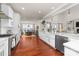 Bright kitchen flows to the dining area, featuring white cabinets and modern appliances at 12860 Westmoreland Farm Rd, Davidson, NC 28036