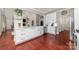 Bright, modern kitchen featuring stainless appliances, white cabinets, and hardwood floors at 12860 Westmoreland Farm Rd, Davidson, NC 28036