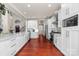 Spacious kitchen featuring white cabinets, stainless steel appliances, and a large center island with ample counter space at 12860 Westmoreland Farm Rd, Davidson, NC 28036