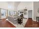 Cozy living room showcasing built-in shelving, fireplace, and large windows at 12860 Westmoreland Farm Rd, Davidson, NC 28036