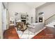 Open-concept living room with fireplace, hardwood floors and staircase at 12860 Westmoreland Farm Rd, Davidson, NC 28036