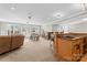 Open concept living area featuring a bar, comfortable seating, and ample natural light at 12860 Westmoreland Farm Rd, Davidson, NC 28036