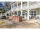 Brick outdoor kitchen on the patio boasts a grill and bar seating near the home at 12860 Westmoreland Farm Rd, Davidson, NC 28036