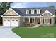 Charming, single-story home with stone and siding, a well-manicured lawn and a two-car garage at 149 Ole Eastpointe Dr, York, SC 29745