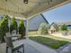 Cozy back patio with seating, string lights, and view of the backyard fireplace, perfect for outdoor entertaining at 1538 Riverwalk Pkwy, Rock Hill, SC 29730