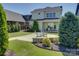 Serene backyard setting with a stone patio, cozy seating, and meticulous landscaping, creating an outdoor oasis at 1538 Riverwalk Pkwy, Rock Hill, SC 29730