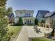 Spacious backyard features a stone fireplace, lush landscaping, and a charming patio area at 1538 Riverwalk Pkwy, Rock Hill, SC 29730
