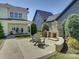 Relaxing backyard patio featuring an outdoor fireplace, seating, and manicured landscaping for serene outdoor living at 1538 Riverwalk Pkwy, Rock Hill, SC 29730