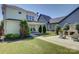 Expansive backyard featuring a patio area, lush lawn, complemented by tasteful landscaping and mature trees at 1538 Riverwalk Pkwy, Rock Hill, SC 29730