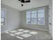Neutral bedroom features three windows and a ceiling fan with carpeted floors at 1538 Riverwalk Pkwy, Rock Hill, SC 29730