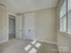 Well lit bedroom with carpet flooring, a window with bright natural light, and neutral colored walls at 1538 Riverwalk Pkwy, Rock Hill, SC 29730