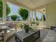 Spacious covered porch with stylish outdoor furniture and a view of the neighborhood at 1538 Riverwalk Pkwy, Rock Hill, SC 29730