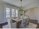 Well-lit dining area with bright windows and views to outside, modern chandelier, and seating for six at 1538 Riverwalk Pkwy, Rock Hill, SC 29730