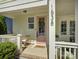 Inviting front porch with seating, stylish decor, and a charming pink door, perfect for relaxation at 1538 Riverwalk Pkwy, Rock Hill, SC 29730