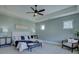 A bright main bedroom with a tray ceiling, large windows, and stylish furniture at 1538 Riverwalk Pkwy, Rock Hill, SC 29730