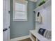 Charming mudroom with white bench, coat hooks, and a window for natural light at 1538 Riverwalk Pkwy, Rock Hill, SC 29730
