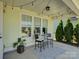 Exterior patio area with a cozy bistro set and festive string lights at 1538 Riverwalk Pkwy, Rock Hill, SC 29730