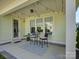Back porch with chairs, string lights, and a modern outdoor rug at 1538 Riverwalk Pkwy, Rock Hill, SC 29730