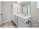 Modern bathroom featuring a double sink vanity, white cabinets, and wood-look flooring at 162 S Sycamore St, Mooresville, NC 28115