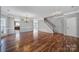 Open living space with hardwood floors, a staircase, and a view into the kitchen; chandelier included at 1766 Canebrook Gln, York, SC 29745