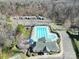 Aerial view of community pool with lounge chairs, clubhouse, playground and recreational vehicle parking at 1766 Canebrook Gln, York, SC 29745