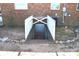 Exterior view of the basement entry with white picket fence and brick surround at 1886 Buffalo Shoals Rd, Statesville, NC 28677