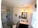 Modern bathroom with a marble shower, sleek vanity, and updated fixtures at 207 Planters Row Rd, Iron Station, NC 28080