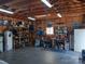 Spacious garage filled with tools and equipment, featuring concrete floors and overhead lighting at 207 Planters Row Rd, Iron Station, NC 28080