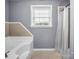 Relaxing bathroom featuring a soaking tub, tile accent, and a separate shower with a white curtain at 2100 Lincolnton Hwy, Cherryville, NC 28021