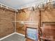 Walk-in closet featuring ample shelving for storage, brick wall, and carpeted floor at 2100 Lincolnton Hwy, Cherryville, NC 28021