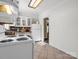 This kitchen features classic appliances and bright, neutral cabinets at 2100 Lincolnton Hwy, Cherryville, NC 28021