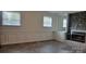 Bright living room with windows, a stone fireplace, and herringbone floors at 2100 Lincolnton Hwy, Cherryville, NC 28021