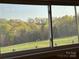 Window view of the expansive green lawn and treeline beyond at 2137 Old Latter Rd, Newton, NC 28658