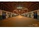 Interior view of horse barn with wooden stalls, beamed ceiling, and dirt floor running down the middle of the barn at 2137 Old Latter Rd, Newton, NC 28658