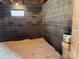 Unfinished basement featuring cinder block walls, a small window, and flooring covered in wood shavings at 2137 Old Latter Rd, Newton, NC 28658