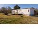 Exterior view of a modular home with a deck and ramp, showcasing accessibility and outdoor living space at 2137 Old Latter Rd, Newton, NC 28658