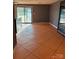 Open living room with tile flooring, sliding glass doors to the backyard and contemporary neutral paint at 2137 Old Latter Rd, Newton, NC 28658