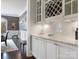 Bar area featuring white cabinetry, granite countertops, wine rack, and subway tile backsplash at 2432 Westfield Rd, Charlotte, NC 28207