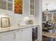 Elegant bar area with granite countertop, wine refrigerator, and view to the dining room at 2432 Westfield Rd, Charlotte, NC 28207
