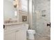 Stylish bathroom featuring marble countertop, white cabinets and tiled glass shower at 2432 Westfield Rd, Charlotte, NC 28207
