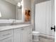 Bright bathroom featuring a white vanity with marble countertop and classic black and white tiled floors at 2432 Westfield Rd, Charlotte, NC 28207