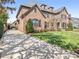 Elegant brick home with manicured lawn and driveway leading to attached garage, bathed in sunlight at 2432 Westfield Rd, Charlotte, NC 28207